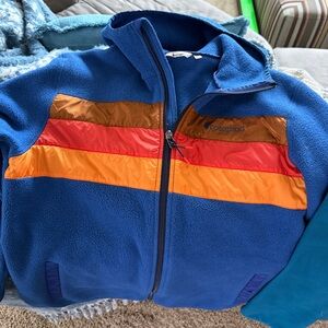 Cotopaxi Fleece Hooded Jacket Blue with Red and Orange Stripes